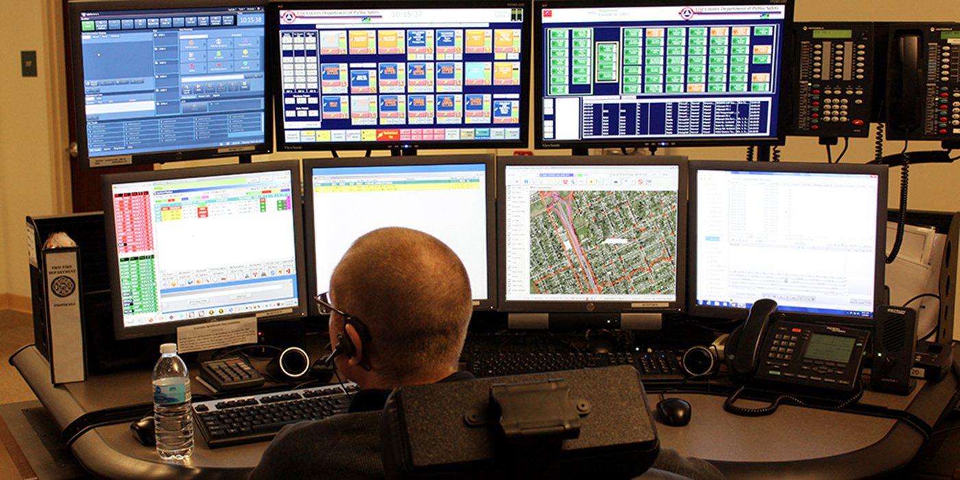 The 911 call taker looks at computer monitors in the Erie County 911 Center